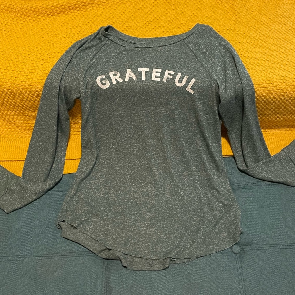 Green lightweight long sleeve shirt. “Grateful” written in white.